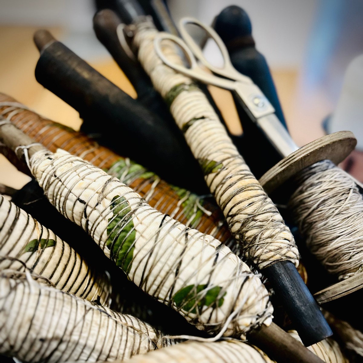 Image Fabric wrapped around spools during process of botanical printing.