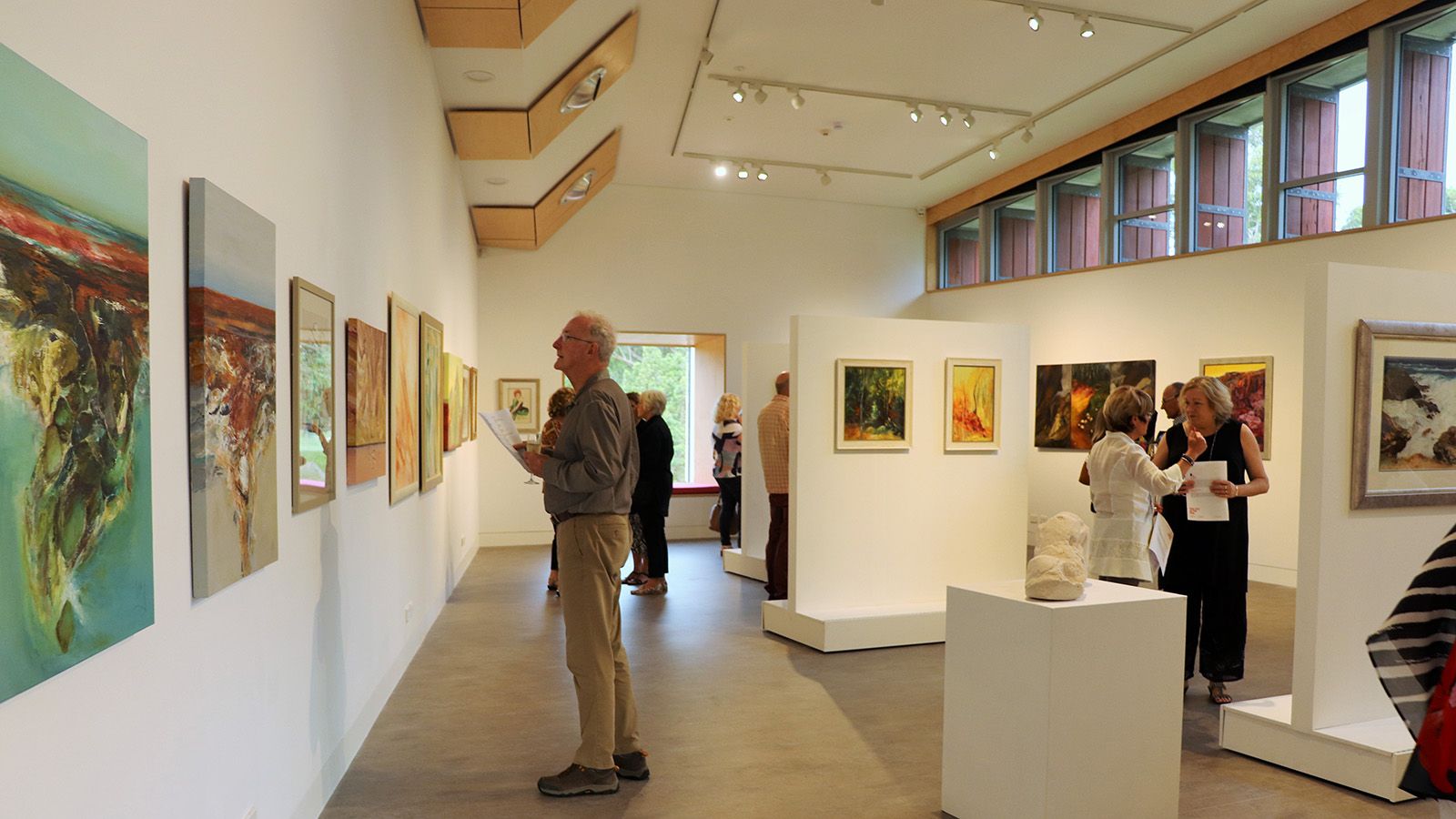 People viewing artworks on the walls of the Basil Sellers Exhibition Centre banner image
