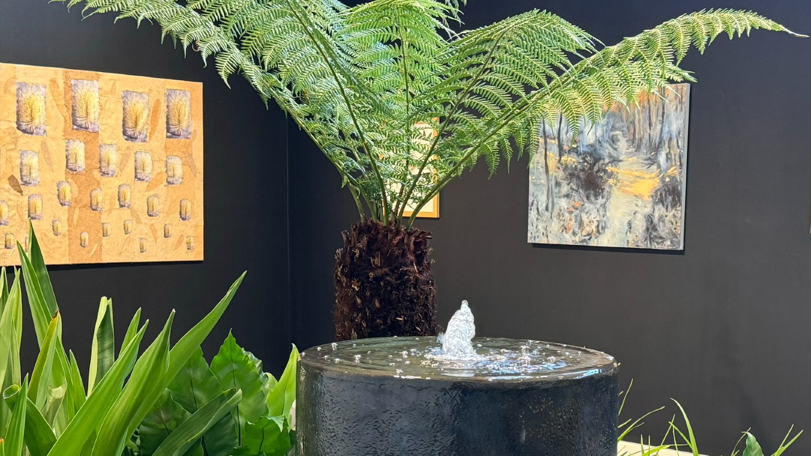 Plants and a water feature in a gallery space.